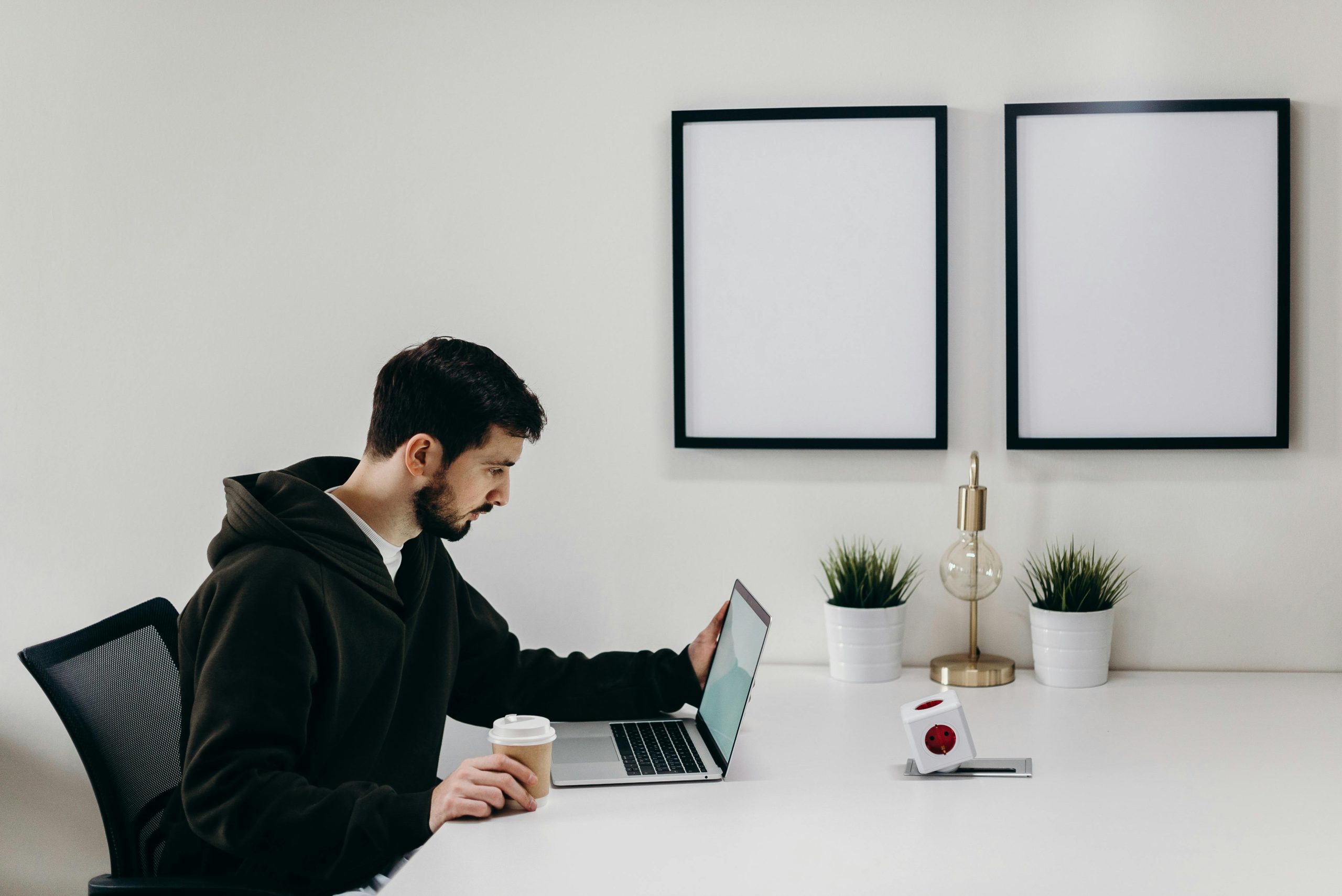 Recent graduate using ResumeShaperAI on a laptop to improve resume and boost interview opportunities